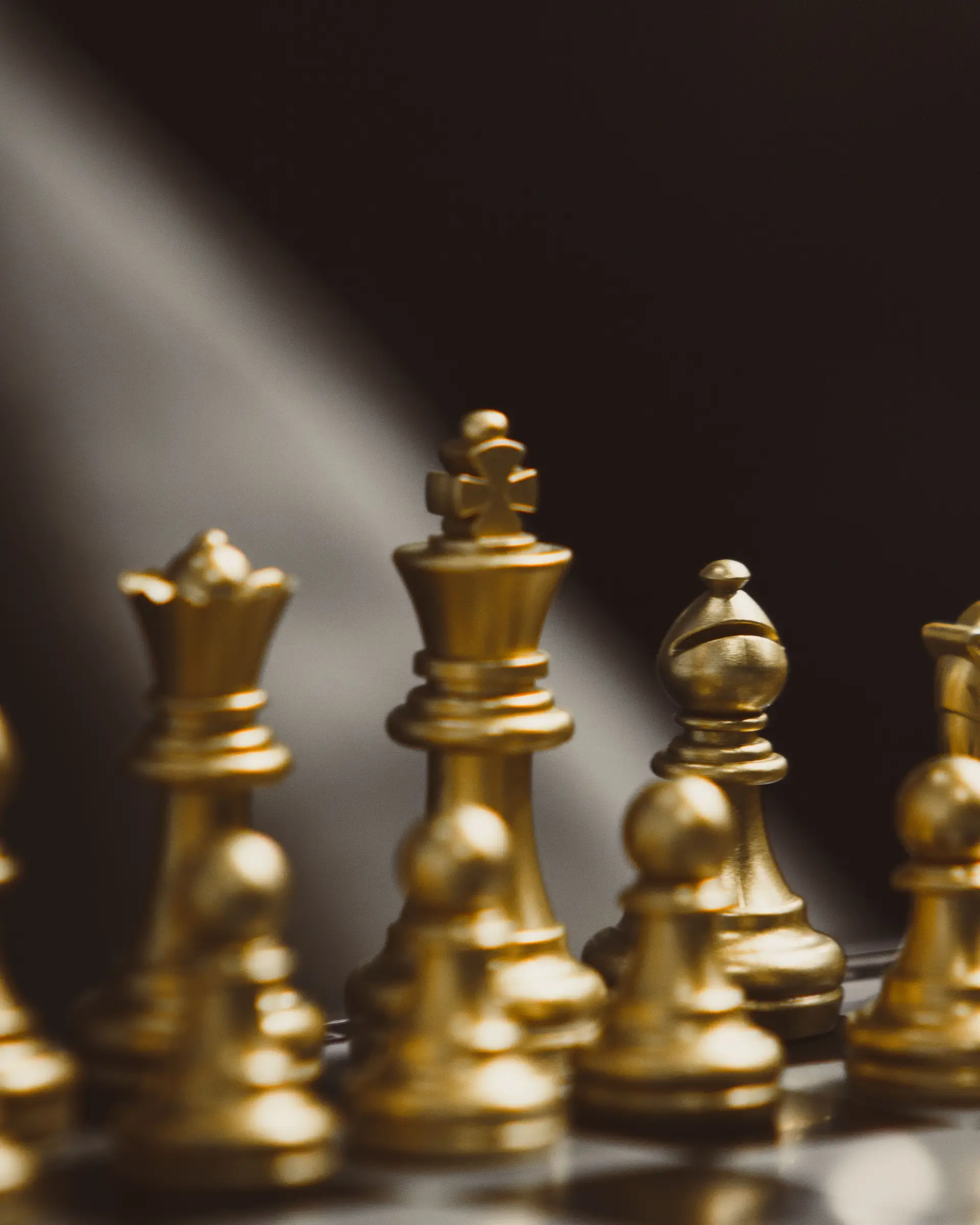 Elegant golden chess pieces on a board